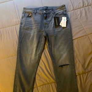 Brand new gray distressed jeans